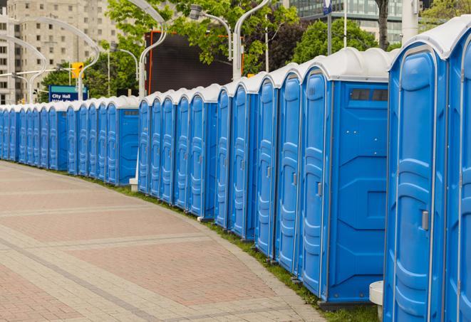 a line of brightly-colored portable restrooms, perfect for outdoor festivals and concerts in Arvin, CA